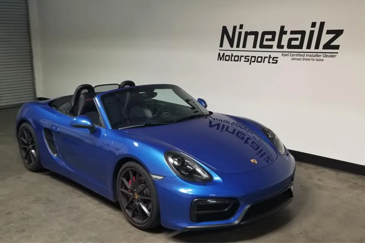 Front view of blue Porsche Boxster GTS.
